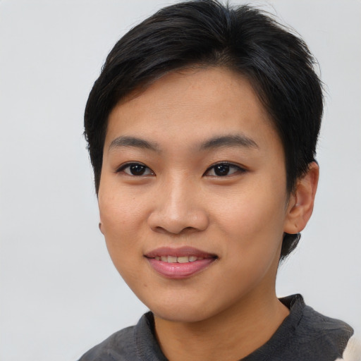 Joyful asian young-adult female with short  black hair and brown eyes