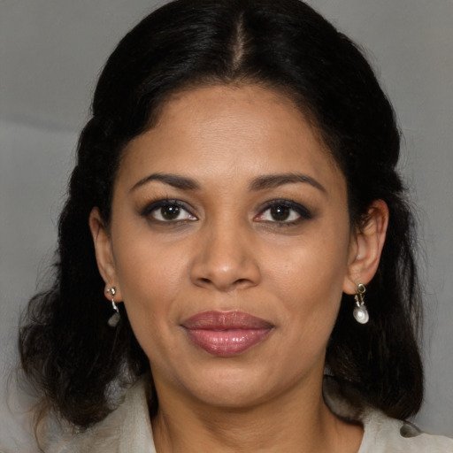 Joyful black young-adult female with medium  brown hair and brown eyes
