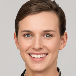 Joyful white young-adult female with short  brown hair and grey eyes