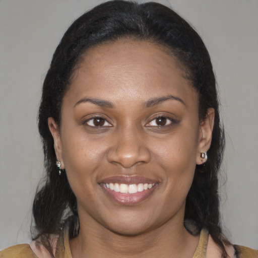 Joyful black young-adult female with medium  brown hair and brown eyes