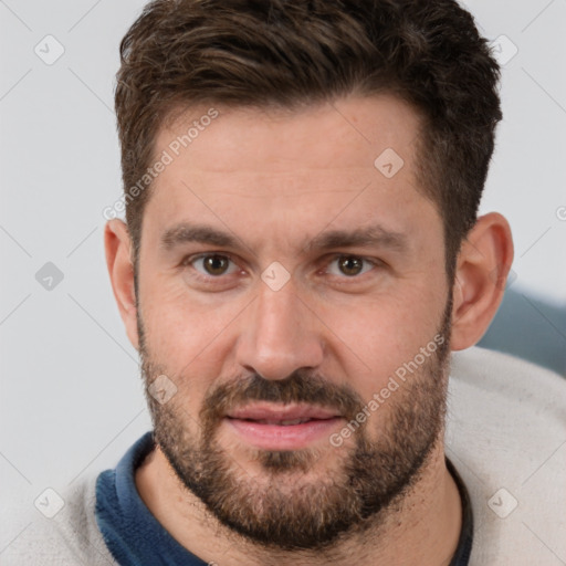 Joyful white adult male with short  brown hair and brown eyes