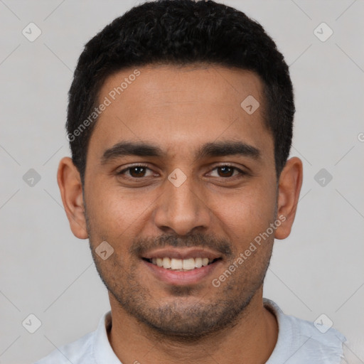 Joyful latino young-adult male with short  black hair and brown eyes