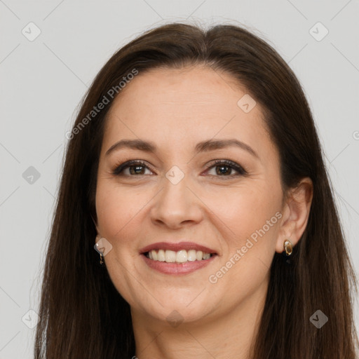 Joyful white adult female with long  brown hair and brown eyes