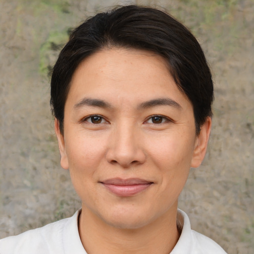 Joyful asian young-adult female with short  brown hair and brown eyes