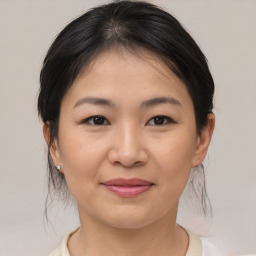 Joyful asian young-adult female with medium  brown hair and brown eyes