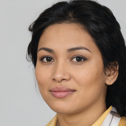 Joyful latino young-adult female with medium  brown hair and brown eyes