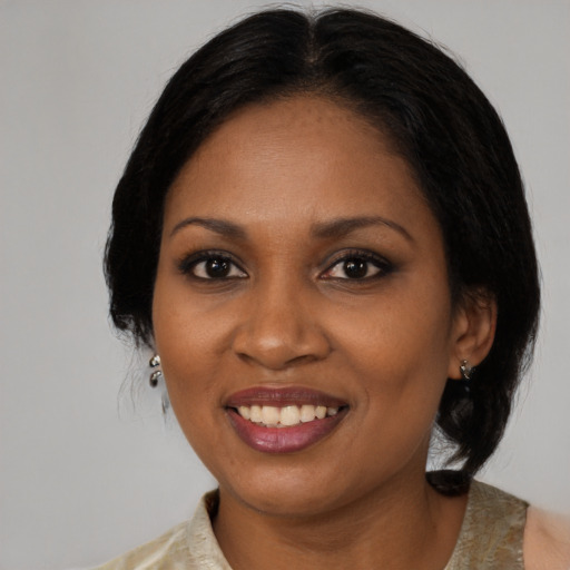 Joyful black adult female with medium  brown hair and brown eyes