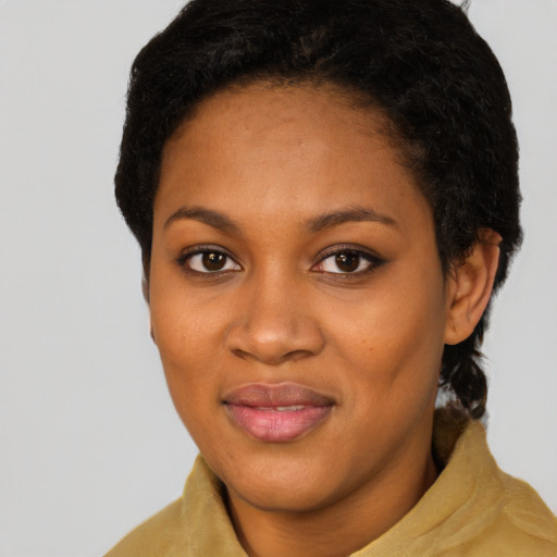 Joyful black young-adult female with short  black hair and brown eyes