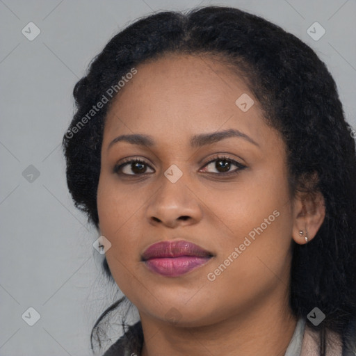 Joyful black young-adult female with long  black hair and brown eyes