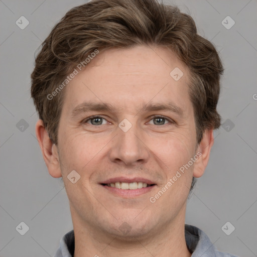 Joyful white adult male with short  brown hair and grey eyes