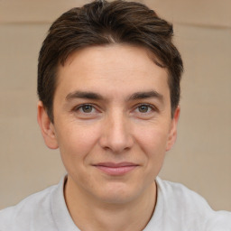 Joyful white young-adult male with short  brown hair and brown eyes