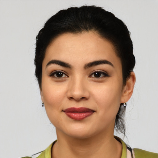 Joyful latino young-adult female with medium  black hair and brown eyes