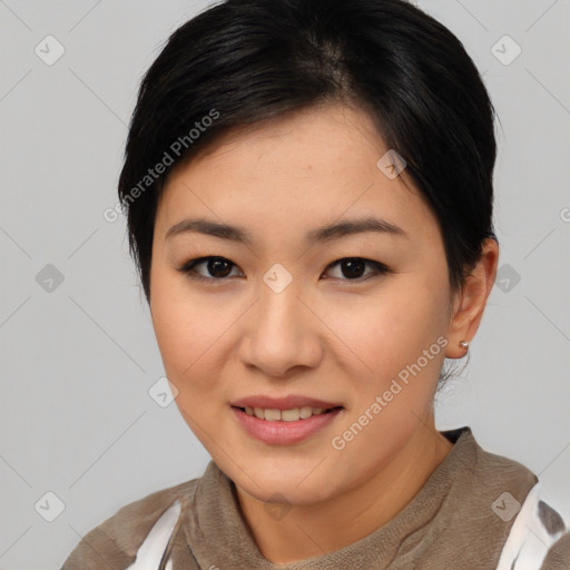 Joyful asian young-adult female with short  black hair and brown eyes