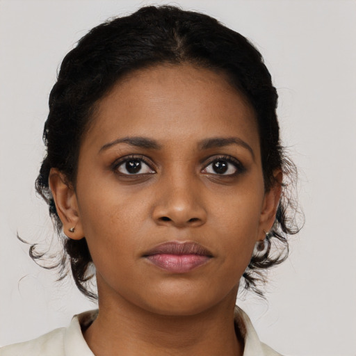 Joyful black young-adult female with medium  brown hair and brown eyes