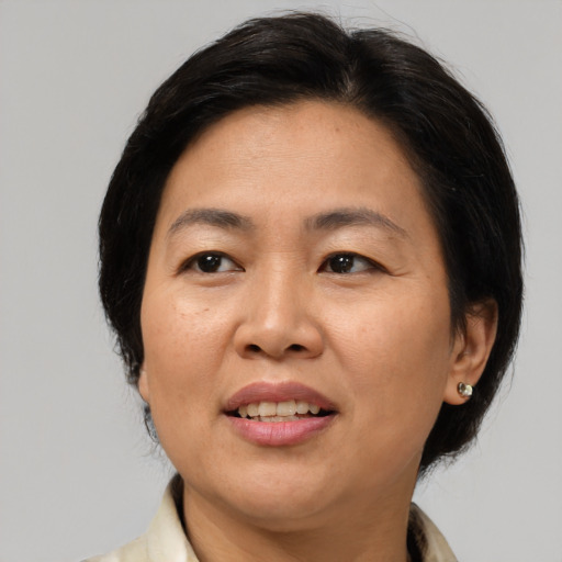 Joyful asian adult female with medium  brown hair and brown eyes