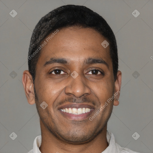 Joyful latino young-adult male with short  black hair and brown eyes