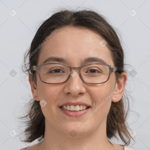 Joyful white adult female with medium  brown hair and brown eyes