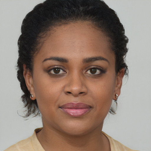 Joyful black young-adult female with short  brown hair and brown eyes