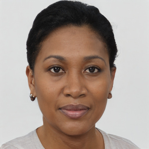 Joyful black young-adult female with short  black hair and brown eyes
