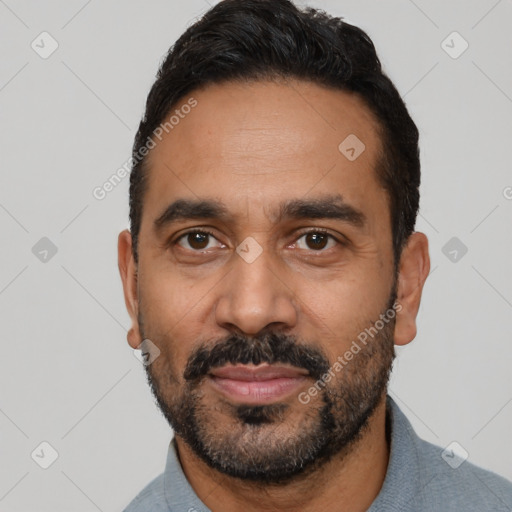 Joyful black adult male with short  black hair and brown eyes