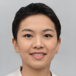 Joyful asian young-adult female with short  brown hair and brown eyes