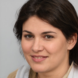 Joyful white adult female with medium  brown hair and brown eyes