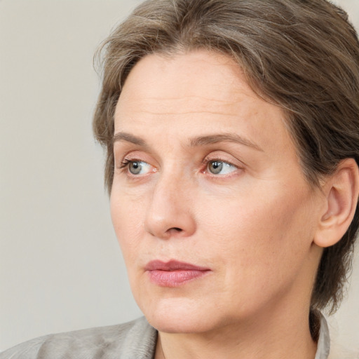 Neutral white adult female with medium  brown hair and grey eyes