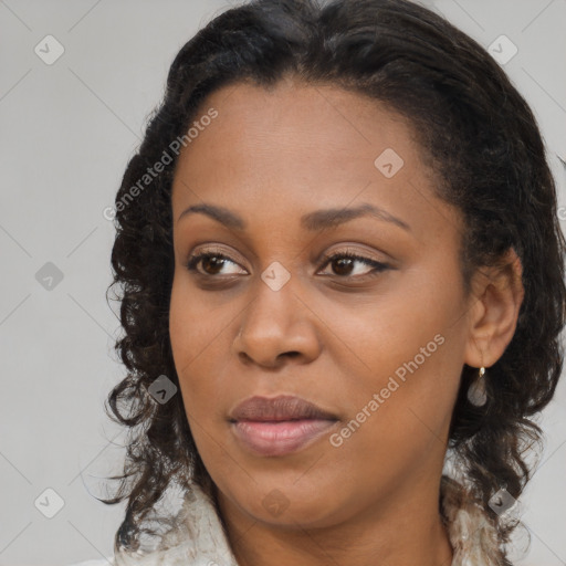 Joyful black young-adult female with long  brown hair and brown eyes