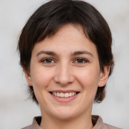 Joyful white young-adult female with medium  brown hair and brown eyes