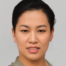 Joyful asian young-adult female with short  black hair and brown eyes