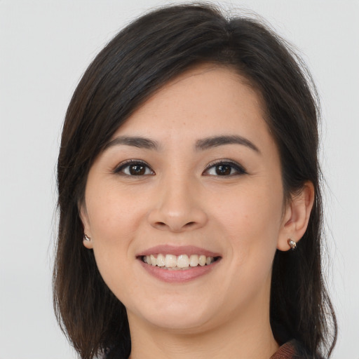 Joyful asian young-adult female with long  brown hair and brown eyes