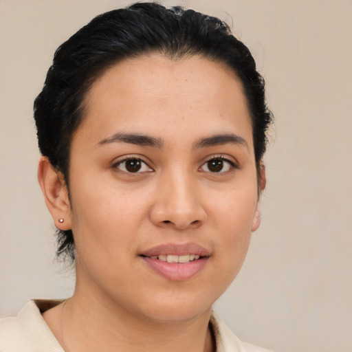 Joyful latino young-adult female with short  brown hair and brown eyes