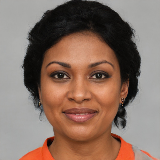 Joyful black young-adult female with medium  black hair and brown eyes
