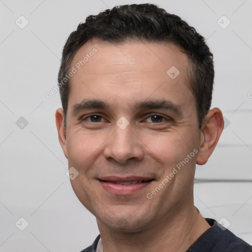 Joyful white young-adult male with short  black hair and brown eyes