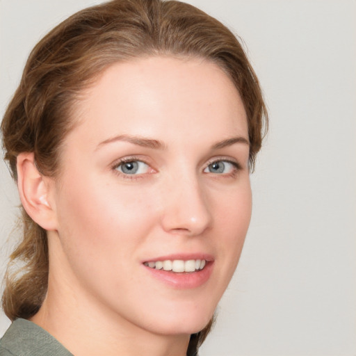 Joyful white young-adult female with medium  brown hair and blue eyes