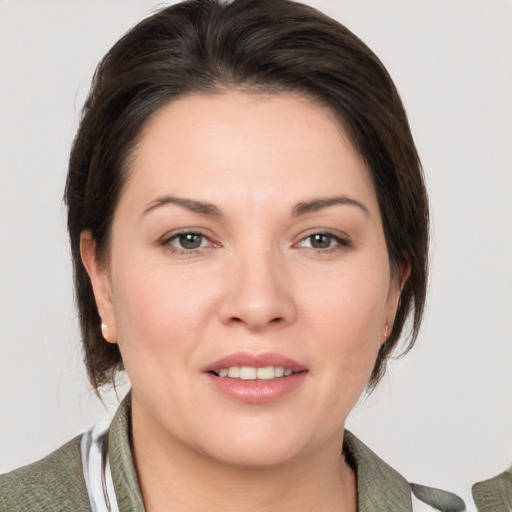 Joyful white young-adult female with medium  brown hair and brown eyes