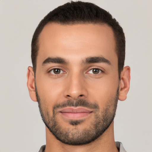 Joyful white young-adult male with short  black hair and brown eyes