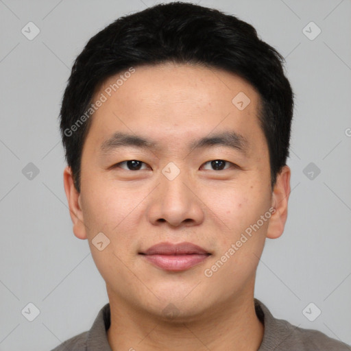 Joyful asian young-adult male with short  black hair and brown eyes