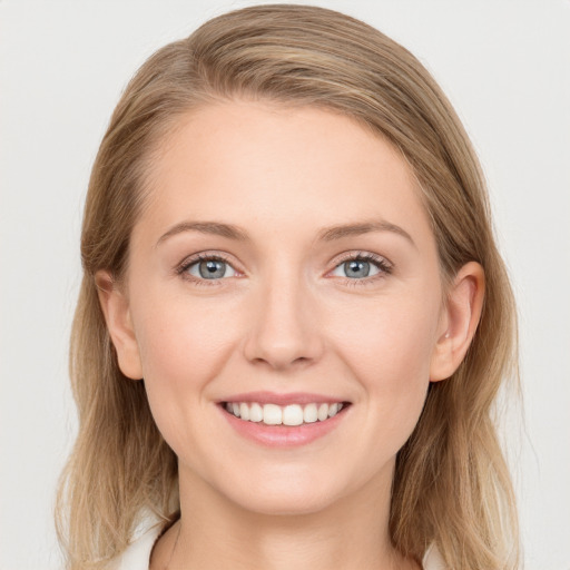 Joyful white young-adult female with long  brown hair and blue eyes