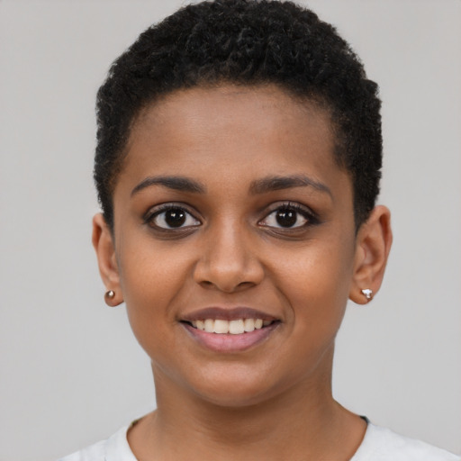 Joyful black young-adult female with short  black hair and brown eyes