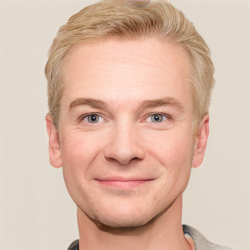 Joyful white adult male with short  brown hair and grey eyes