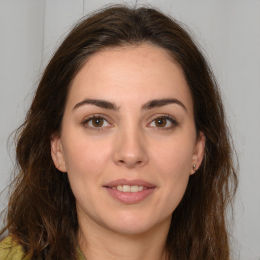 Joyful white young-adult female with long  brown hair and brown eyes