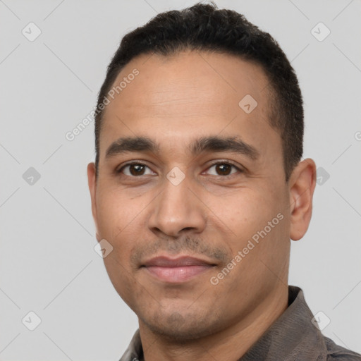 Joyful white young-adult male with short  black hair and brown eyes