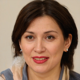 Joyful white adult female with medium  brown hair and brown eyes