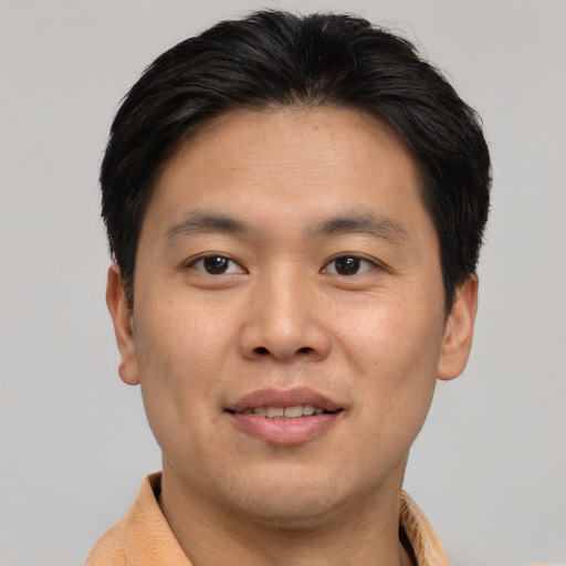 Joyful asian young-adult male with short  brown hair and brown eyes