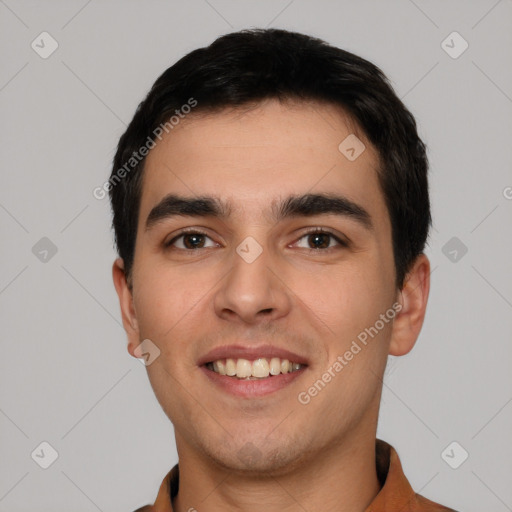 Joyful white young-adult male with short  black hair and brown eyes