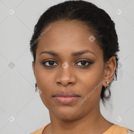 Joyful black young-adult female with short  black hair and brown eyes