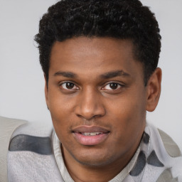 Joyful black young-adult male with short  brown hair and brown eyes