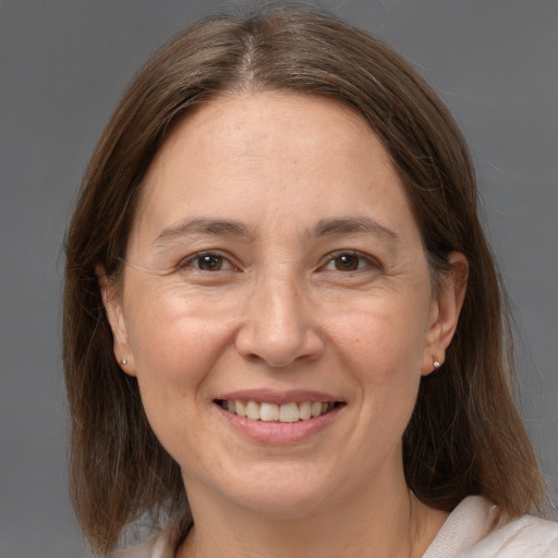 Joyful white adult female with medium  brown hair and brown eyes