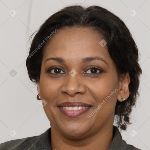 Joyful black adult female with medium  brown hair and brown eyes